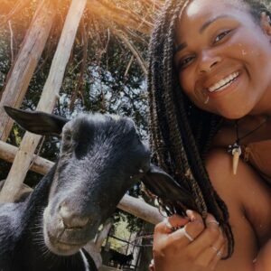 A woman smiling next to a goat. A Q&A with Highstead’s New Conservation Interns.
